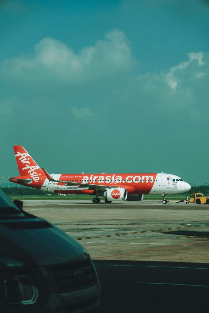 AirAsia airplane on the runway at Ho Chi Minh City airport, ready for takeoff.