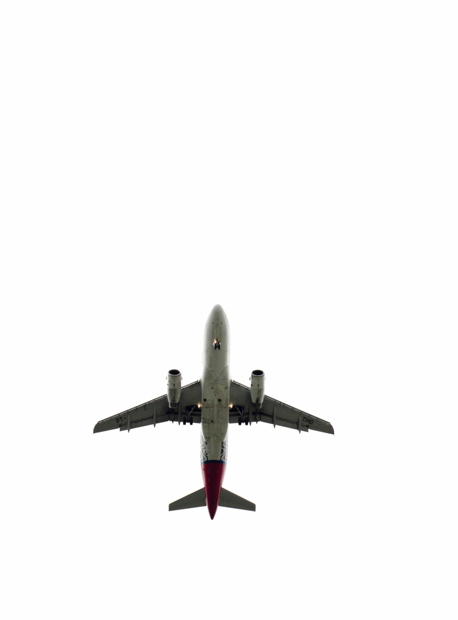 Silhouette of a commercial airplane against a minimalistic sky, symbolizing modern air travel.